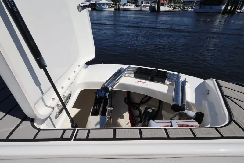 Slide: The Image of An open storage compartment on a boat with a view of the water in the background. - 36