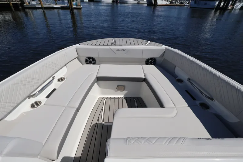 Slide: The Image of The image shows the spacious bow area of a Sea Ray SDX 270 Outboard with white upholstery. - 32