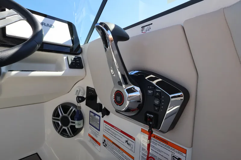 Slide: The Image of Close-up of the throttle and controls on a 2027 Sea Ray SDX 270 Outboard. - 23