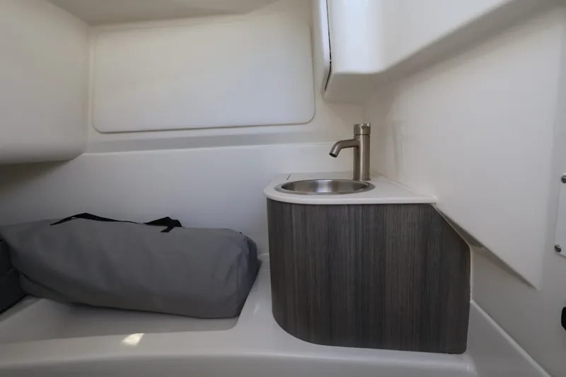 Slide: The Image of Interior of a Sea Ray SDX 270 Outboard with a sink and a gray bag. - 29