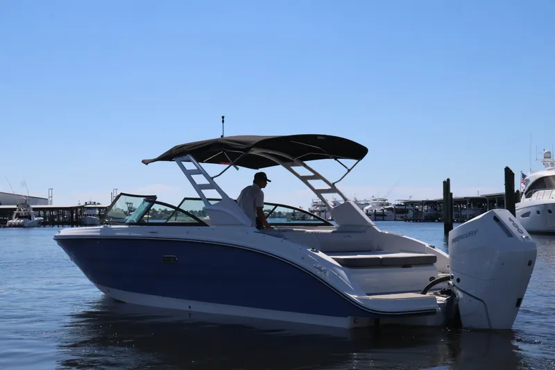 Slide: The Image of 2027 Sea Ray SDX 270 Outboard on the water with a sunshade and outboard motor. - 7