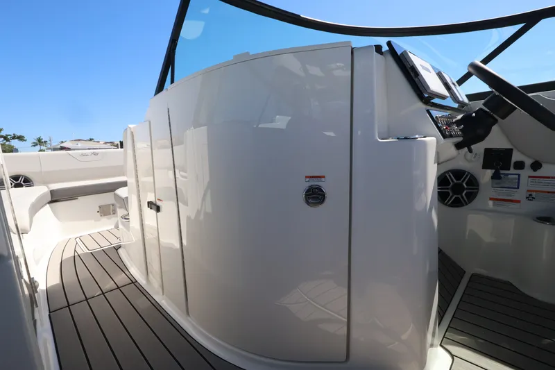 Slide: The Image of The image shows the cockpit of a 2027 Sea Ray SDX 270 Outboard with modern controls. - 27