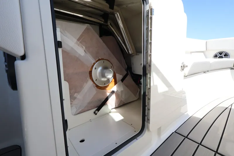 Slide: The Image of Storage compartment on a 2027 Sea Ray SDX 270 Outboard with secured equipment. - 31