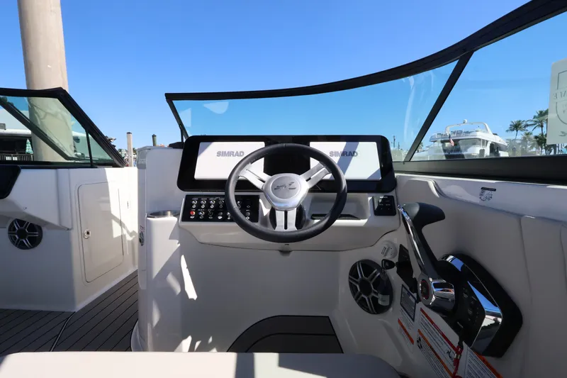 Slide: The Image of Helm of the Sea Ray SDX 270 Outboard featuring a modern design and Simrad displays. - 22