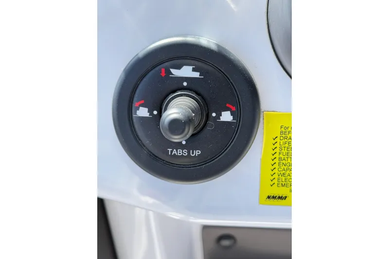 Slide: The Image of Control knob on 2022 Axopar 22 T-Top boat dashboard with trim tab settings. - 13