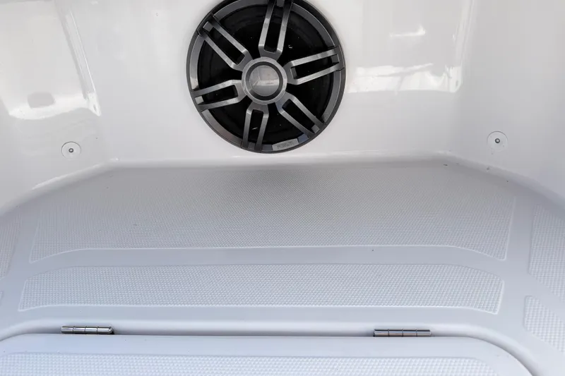 Slide: The Image of Axopar 22 T-Top 2022 boat interior with speaker and textured flooring. - 21