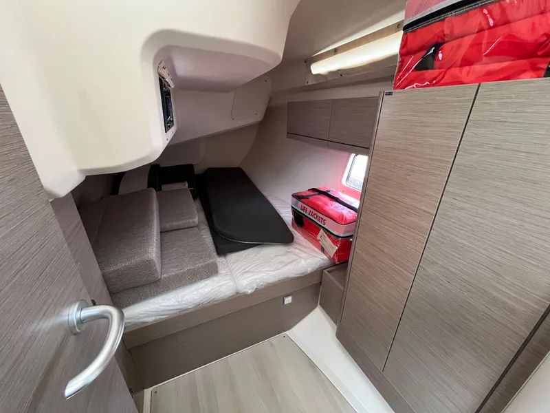 Slide: The Image of 2021 Hanse 418 yacht cabin interior with bed, storage, and window. - 24