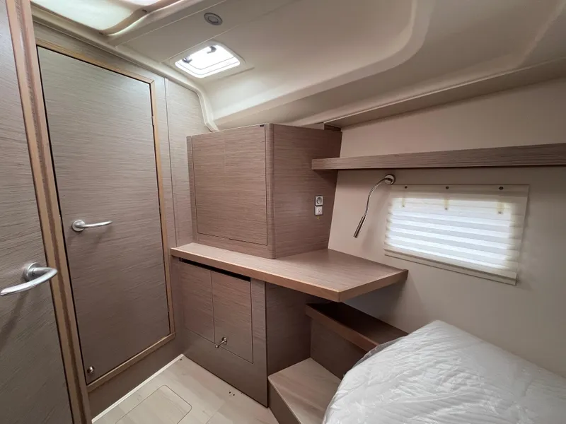Slide: The Image of Interior of 2021 Hanse 418 yacht cabin with modern wood finish and compact design. - 49
