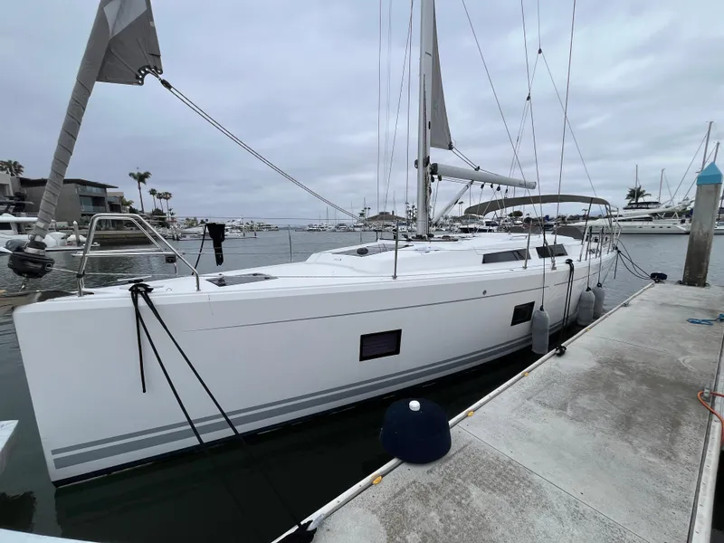 Slide: The Image of 2021 Hanse 418 yacht docked at marina under cloudy sky. - 5