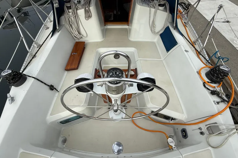 Slide: The Image of Cockpit of 1988 Ericson 32-200 sailboat with steering wheel and navigation instruments. - 10