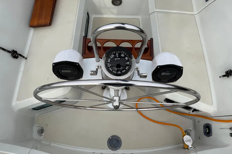 Slide: The Image of Steering wheel and compass on a 1988 Ericson 32-200 sailboat cockpit. - 11