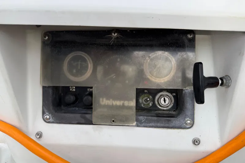 Slide: The Image of Control panel of a 1988 Ericson 32-200 sailboat with gauges and switches. - 12