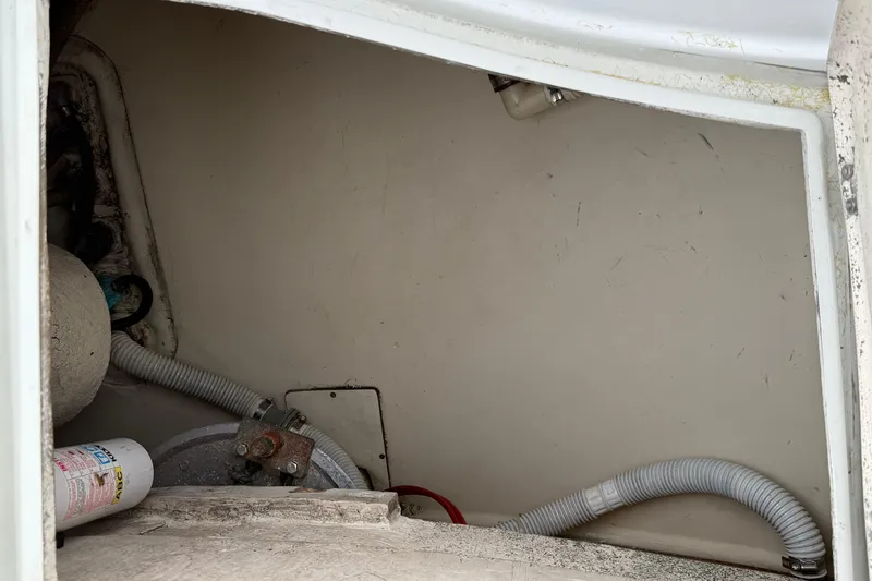 Slide: The Image of Interior view of 1988 Ericson 32-200 sailboat compartment with hoses and equipment. - 14