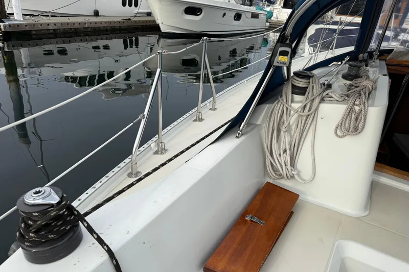 Slide: The Image of 1988 Ericson 32-200 sailboat deck with ropes and winches at marina. - 15