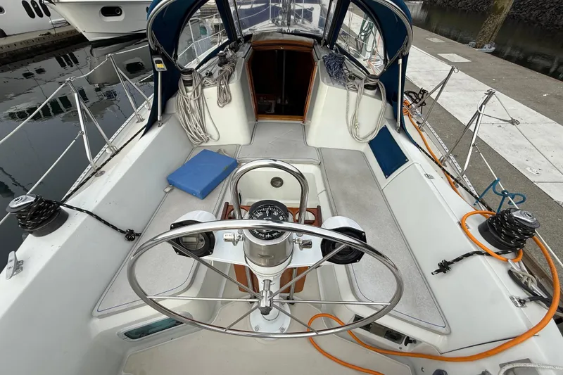 Slide: The Image of Cockpit of 1988 Ericson 32-200 sailboat with steering wheel and nautical equipment. - 18