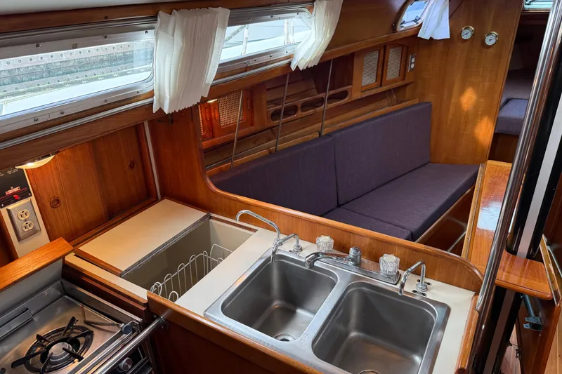 Slide: The Image of Interior of 1988 Ericson 32-200 sailboat with kitchen and seating area. - 21