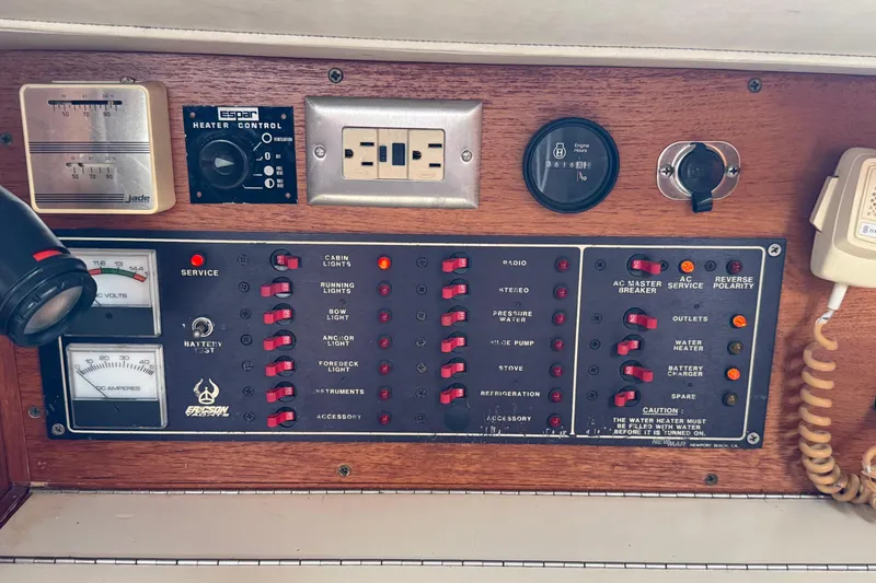 Slide: The Image of Control panel of a 1988 Ericson 32-200 sailboat with various switches and gauges. - 29