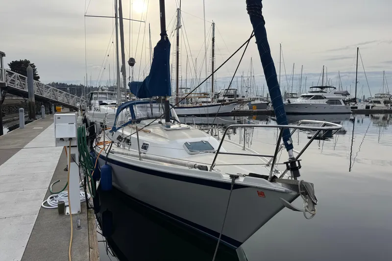 Slide: The Image of Sailboat Ericson 32-200, 1988 model, docked at a marina with calm waters. - 3