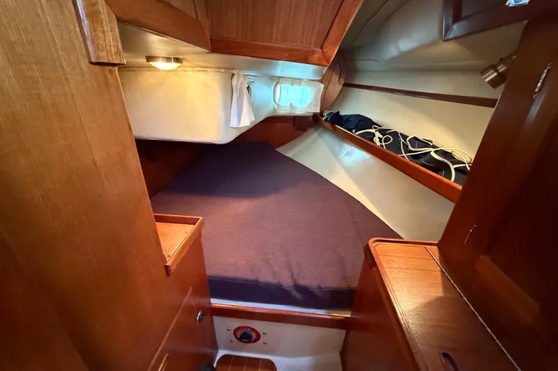 Slide: The Image of Cozy cabin interior of 1988 Ericson 32-200 sailboat with wooden finish and bedding. - 33