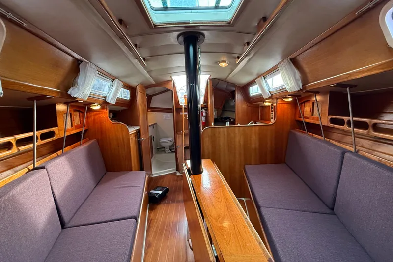 Slide: The Image of Interior of a 1988 Ericson 32-200 sailboat with wooden finishes and cozy seating. - 43