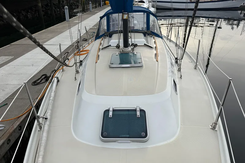 Slide: The Image of 1988 Ericson 32-200 sailboat docked, showcasing deck and hatch details. - 6
