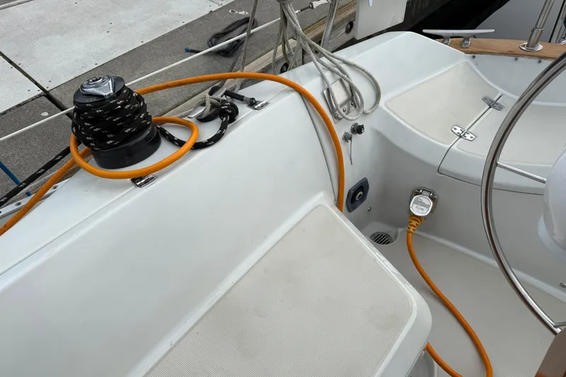 Slide: The Image of Cockpit of 1988 Ericson 32-200 sailboat with winch, ropes, and electrical connections. - 8