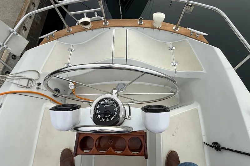 Slide: The Image of Cockpit of 1988 Ericson 32-200 sailboat with steering wheel and compass. - 9