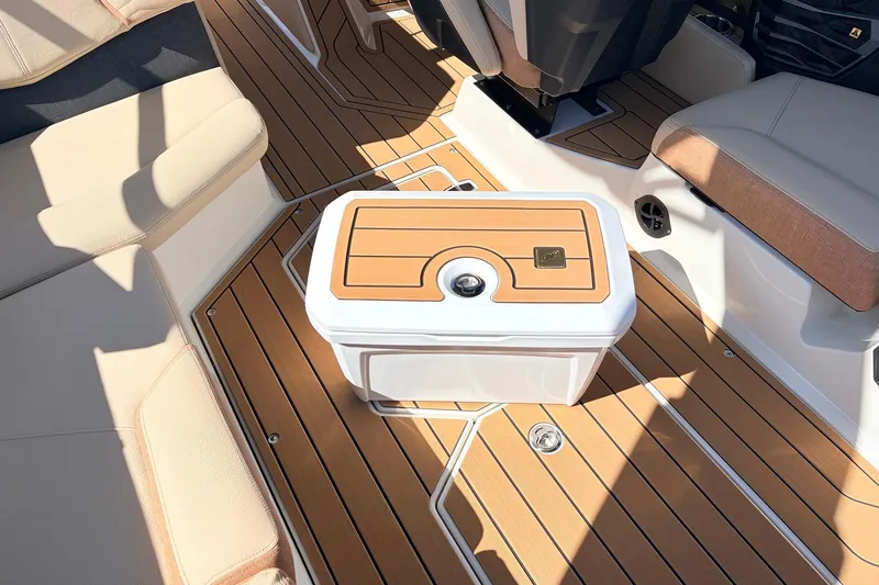 Slide: The Image of 2026 Nautique Super Air Nautique G23 interior with teak flooring and seating. - 56