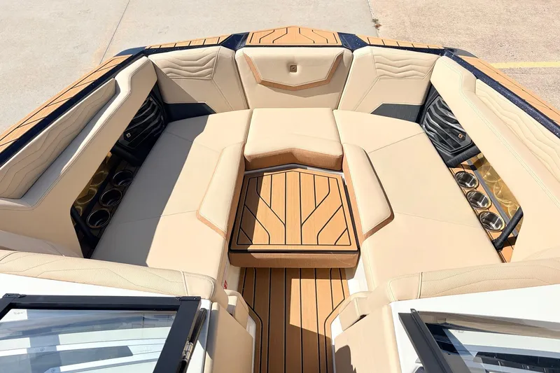 Slide: The Image of Luxurious interior of 2026 Nautique Super Air Nautique G23 boat with tan seating. - 27
