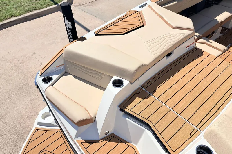 Slide: The Image of 2026 Nautique Super Air Nautique G23 boat with tan seating and teak-style decking. - 65
