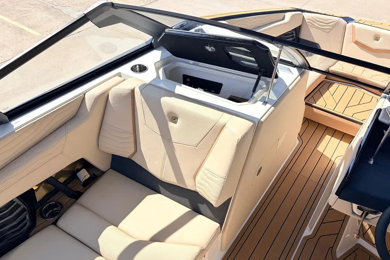 Slide: The Image of 2026 Nautique Super Air Nautique G23 interior with beige seating and teak flooring. - 29