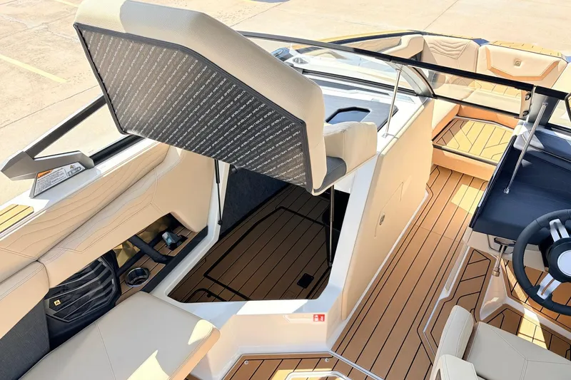 Slide: The Image of 2026 Nautique Super Air Nautique G23 interior with luxurious seating and teak flooring. - 32