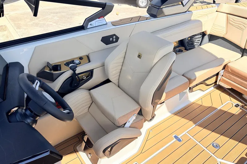 Slide: The Image of 2026 Nautique Super Air Nautique G23 interior with beige seating and modern dashboard. - 50
