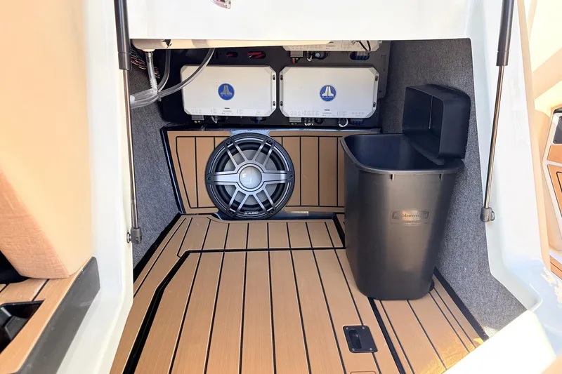 Slide: The Image of 2026 Nautique Super Air Nautique G23 interior with subwoofer and storage compartment. - 33