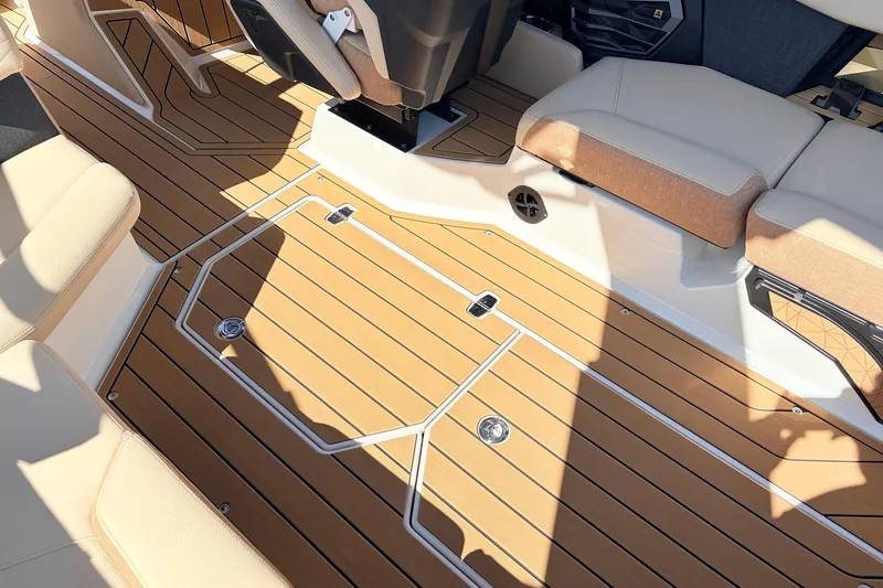 Slide: The Image of 2026 Nautique Super Air Nautique G23 interior with teak flooring and beige seating. - 54