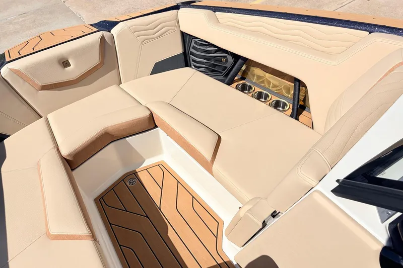 Slide: The Image of Luxurious interior of 2026 Nautique Super Air Nautique G23 boat with beige seating. - 26