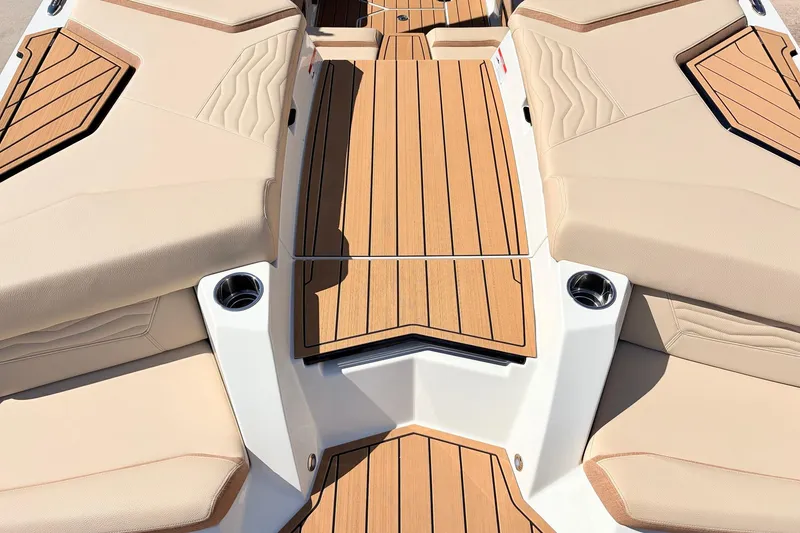 Slide: The Image of 2026 Nautique Super Air Nautique G23 boat interior with teak decking and beige seating. - 67