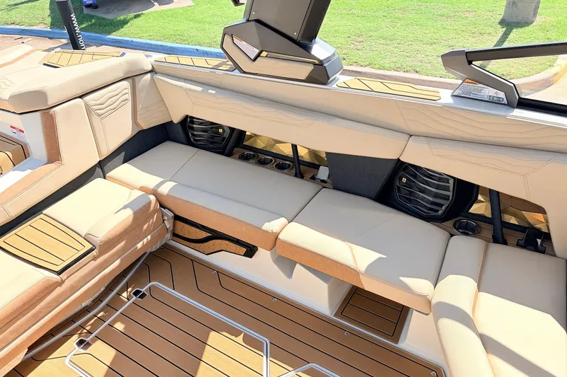 Slide: The Image of Luxurious interior of 2026 Nautique Super Air Nautique G23 boat with beige seating. - 34