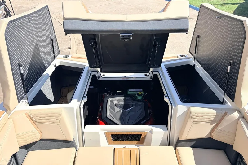 Slide: The Image of 2026 Nautique Super Air Nautique G23 engine compartment with open storage hatches. - 62