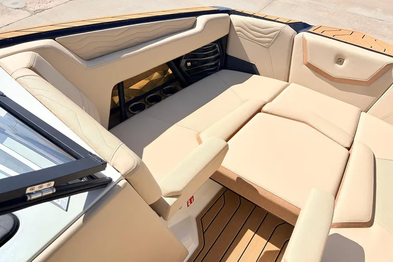 Slide: The Image of Luxurious interior of 2026 Nautique Super Air Nautique G23 boat with beige seating. - 15