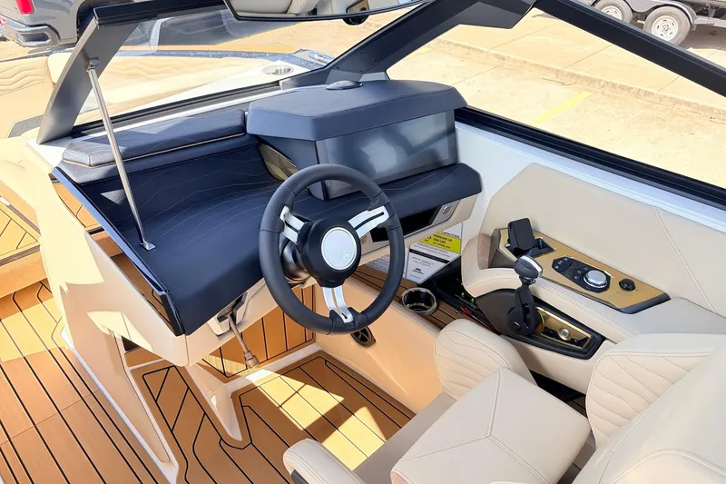 Slide: The Image of Interior of 2026 Nautique Super Air Nautique G23 boat, featuring modern steering and controls. - 51