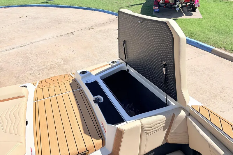 Slide: The Image of 2026 Nautique Super Air Nautique G23 boat with open storage compartment, showcasing luxury seating. - 60