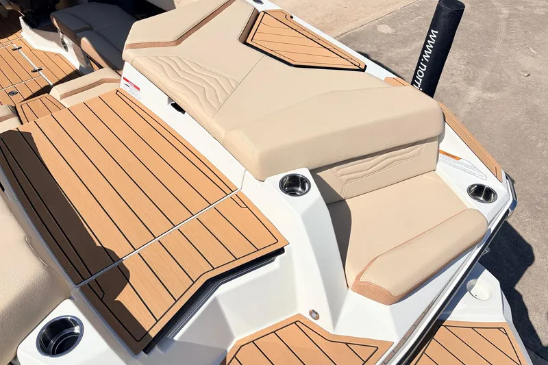 Slide: The Image of 2026 Nautique Super Air Nautique G23 boat with luxurious tan seating and teak-style decking. - 66
