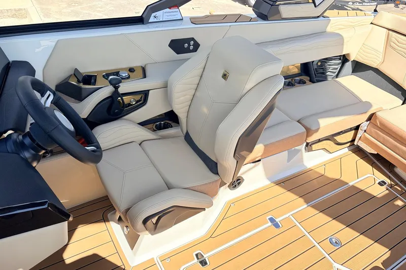 Slide: The Image of Luxurious interior of 2026 Nautique Super Air Nautique G23 boat with beige seating. - 49