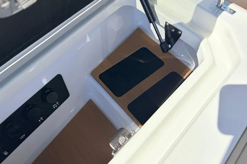 Slide: The Image of Interior view of 2026 Nautique Super Air Nautique G23 boat compartment with controls. - 31
