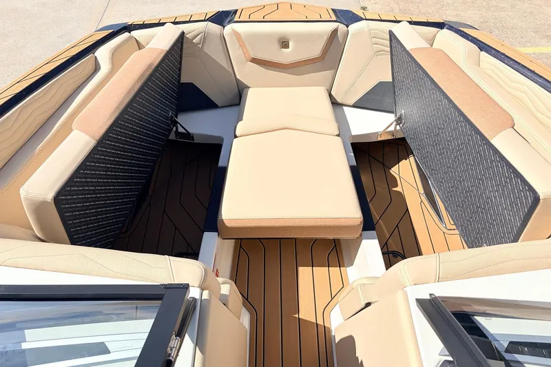 Slide: The Image of Luxurious interior of 2026 Nautique Super Air Nautique G23 boat with beige seating. - 21