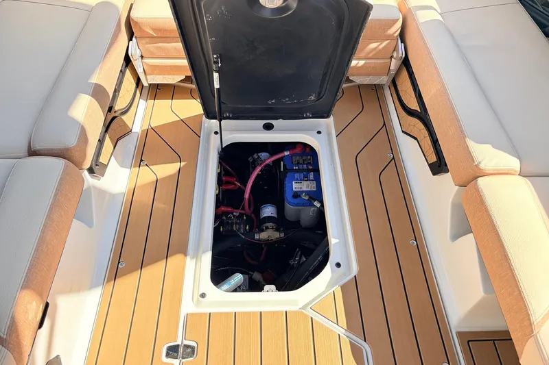 Slide: The Image of 2026 Nautique Super Air Nautique G23 boat interior with open storage compartment. - 58