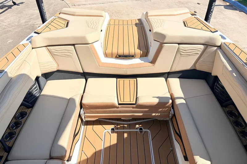 Slide: The Image of Luxurious interior of 2026 Nautique Super Air Nautique G23 boat with beige seating and wood accents. - 37