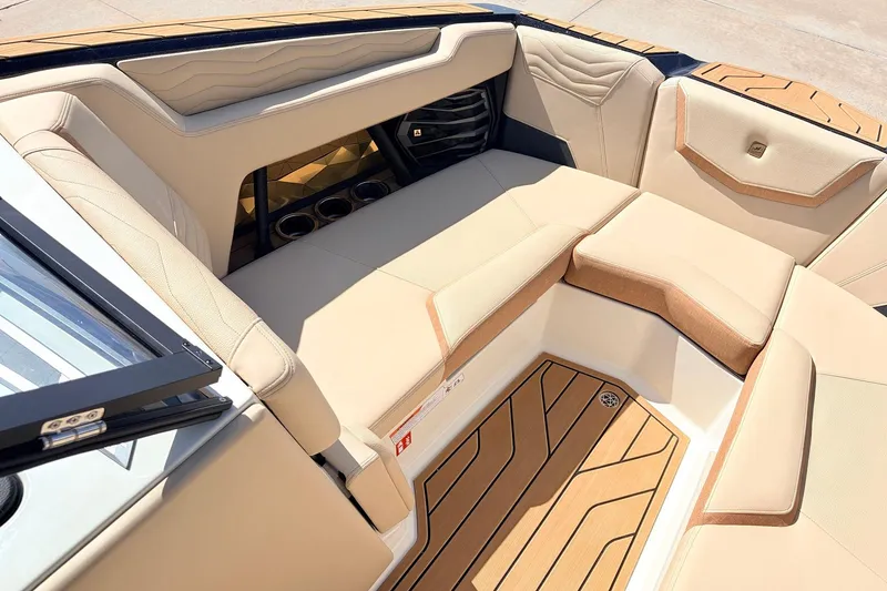 Slide: The Image of Luxurious interior of 2026 Nautique Super Air Nautique G23 with beige seating and wood accents. - 25