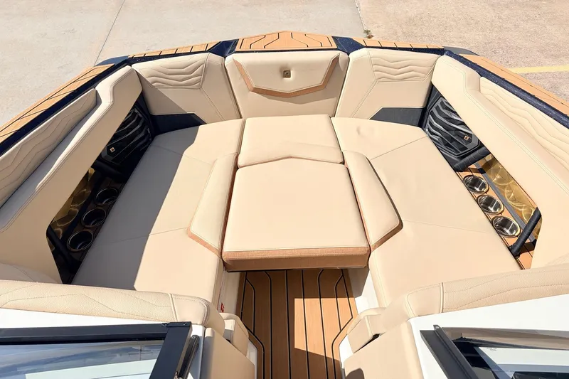 Slide: The Image of Luxurious interior of 2026 Nautique Super Air Nautique G23 boat with beige seating. - 20